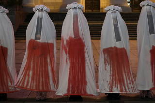 Participants stage a performance during a protest against the ruling imposing a near-total ban on abortion in Warsaw