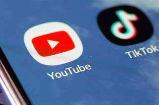 Tik Tok and Youtube app icon are seen on a smartphone in this illustration taken