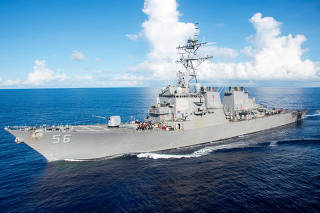 FILE PHOTO: The U.S. Navy Arleigh Burke-class guided-missile destroyer USS John S. McCain maneuvers in the Philippine Sea