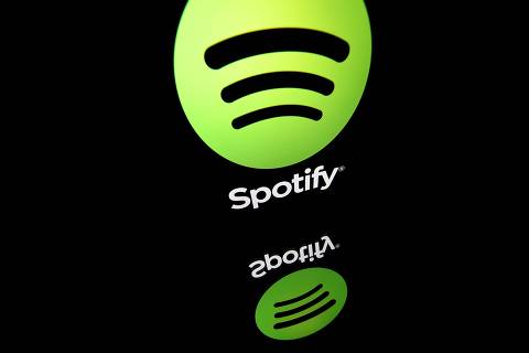 (FILES) This file illustration taken on April 19, 2018 shows the logo of online streaming music service Spotify displayed on a tablet screen in Paris. - Music streaming giant Spotify said Thursday, October 29, 2020 that its number of monthly active users passed the 300-million-mark in third quarter, even as it plunged back into the red. (Photo by Lionel BONAVENTURE / AFP)