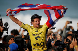 John John Florence of Hawaii celebrates his victory after winning the WSL championship at Supertubo beach in Peniche