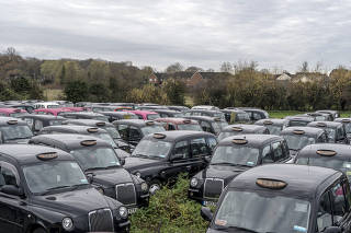 Black cabs in a field near Epping, in southeastern England, on Nov. 26, 2020.  (Andrew Testa/The New York Times)