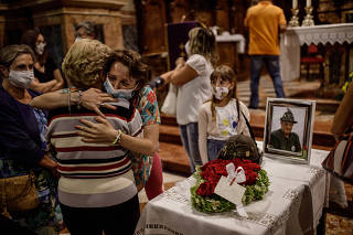 Sara Cagliani is surrounded by family and friends during a Mass in memory of her father, Alberto Cagliani, in Bergamo, Italy, July 24, 2020. (Fabio Bucciarelli/The New York Times)