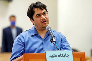 Ruhollah Zam, a dissident journalist who was captured in what Tehran calls an intelligence operation, speaks during his trial in Tehran