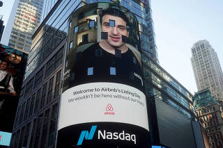 FILE PHOTO: The Nasdaq market site displays an Airbnb sign featuring CEO Brian Chesky on their billboard on the day of their IPO in Times Square