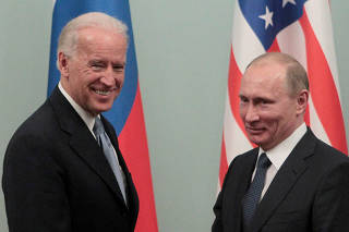 FILE PHOTO: Russian Prime Minister Putin shakes hands with U.S. Vice President Biden during their meeting in Moscow
