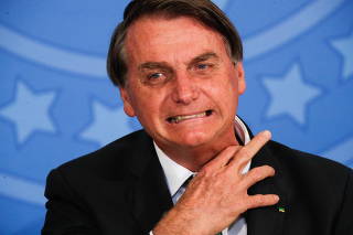 Brazil's President Jair Bolsonaro reacts during the Thanksgiving ceremony, at the Planalto Palace in Brasilia