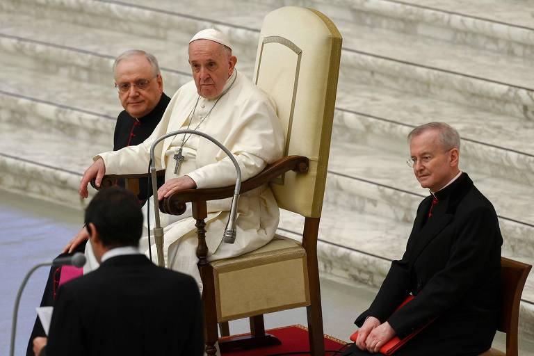 Papa Francisco sentado em um cadeira acompanhando de alguns cardeais romanos