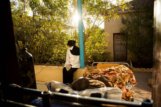 Randa Hassan Mohamed, a nurse, took a coronavirus patient outside for fresh air and sunlight at the Daryeel hospital in Hargeisa, Somalia, Dec. 2, 2020. (Samantha Reinder/The New York Times)
