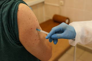 A person receives an injection with Sputnik V (Gam-COVID-Vac) vaccine against the coronavirus disease (COVID-19) at a clinic in Minsk