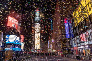 Confetti flies around the ball and countdown clock in Times Square during the virtual New Year's Eve event following the outbreak of the coronavirus disease (COVID-19) in the Manhattan borough of New York City