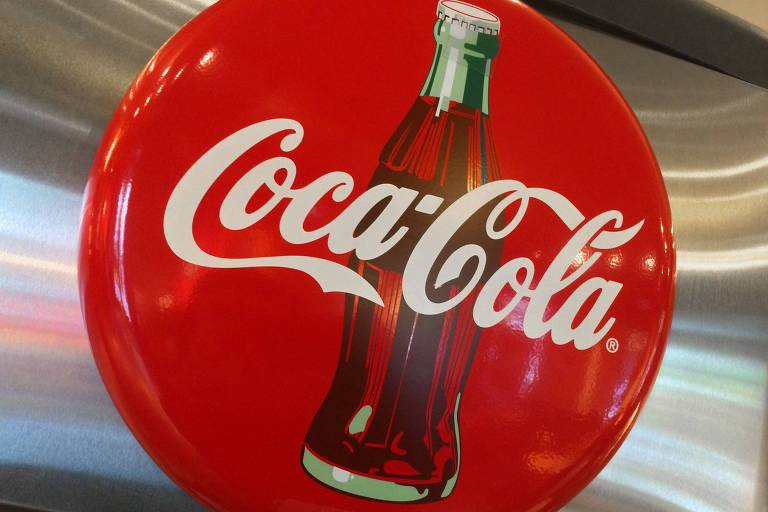 Logo vermelha e branca da Coca-Cola em um restaurante em Washington, nos Estados Unidos; imagem tem uma garrafa de vidro do refrigerante