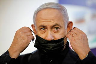 FILE PHOTO: Israeli Prime Minister Benjamin Netanyahu receives COVID-19 vaccine