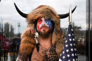 FILE PHOTO: Man poses with his face painted in the colors of the U.S. flag in Washington