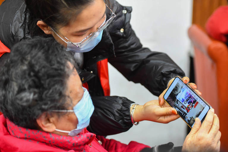 Idosa aprende a usar smartphone em comunidade da província de Hunan, na China