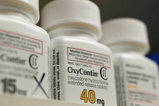 FILE PHOTO: FILE PHOTO: Bottles of prescription painkiller OxyContin made by Purdue Pharma LP sit on a shelf at a local pharmacy in Provo