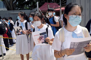 FILE PHOTO: Secondary school students march near a school campus in Hong Kong