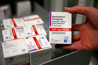 FILE PHOTO: A pharmacist displays a box of tocilizumab at the pharmacy of Cambrai hospital