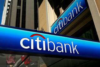 FILE PHOTO: People walk beneath a Citibank branch logo in the financial district of San Francisco, California