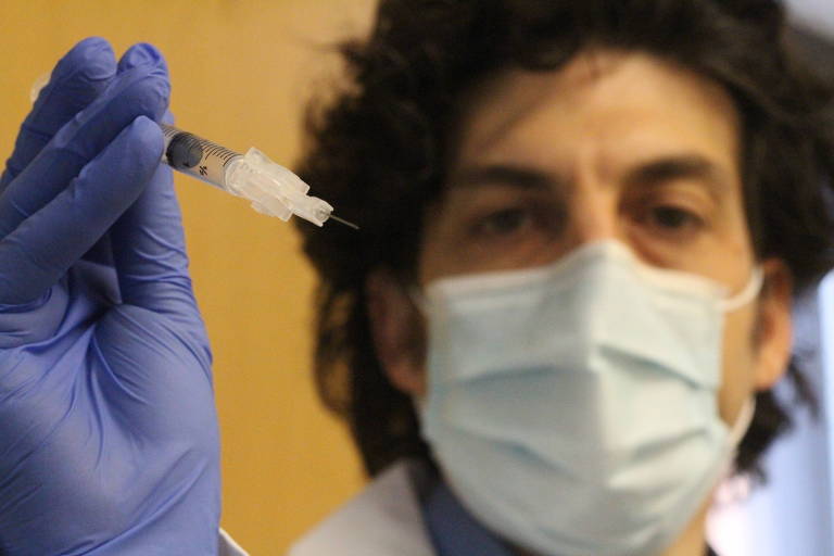 O pesquisador Jordan Feld, do Centro de Doenças do Fígado de Toronto, segura uma injeção com a droga experimental peginterferon-lambda, atualmente em estudo contra Covid-19