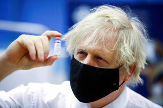 FILE PHOTO: Britain's Prime Minister Boris Johnson visits a vaccination centre at Cwmbran Stadium
