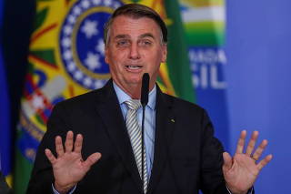Brazil's President Jair Bolsonaro gestures during a ceremony at the Planalto Palace in Brasilia