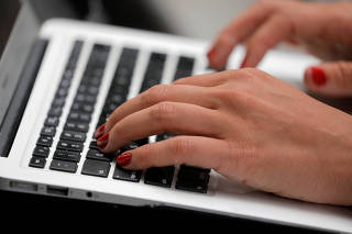 FILE PHOTO: A person types on a laptop computer in Manhattan, New York City