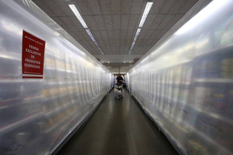 Cortinas plásticas cobrem gôndolas em corredor de supermercado