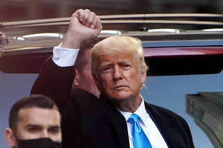 Trump acknowledges people as he gets in his SUV outside Trump Tower in New York City