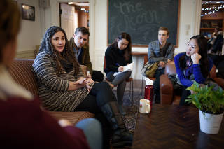 Laurie Santos, a psychology professor at Yale University, left, talks with students after a session of her class at Yale University in New Haven, Conn., Jan. 25, 2018. (Monica Jorge/The New York Times)