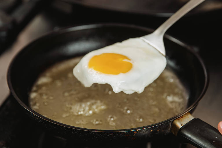 Photo shows egg being cooked in a frying pan