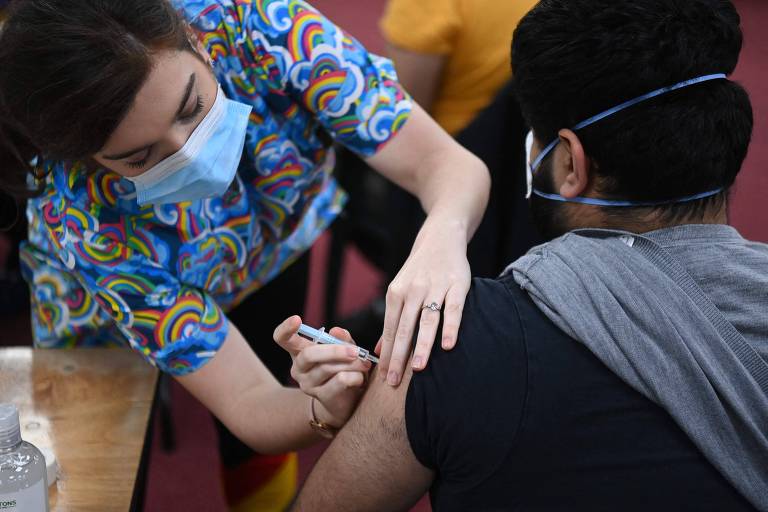 Enfermeira aplica dose do imunizante da AstraZeneca em centro de vacinação instalado dentro de uma mesquita, em Londres