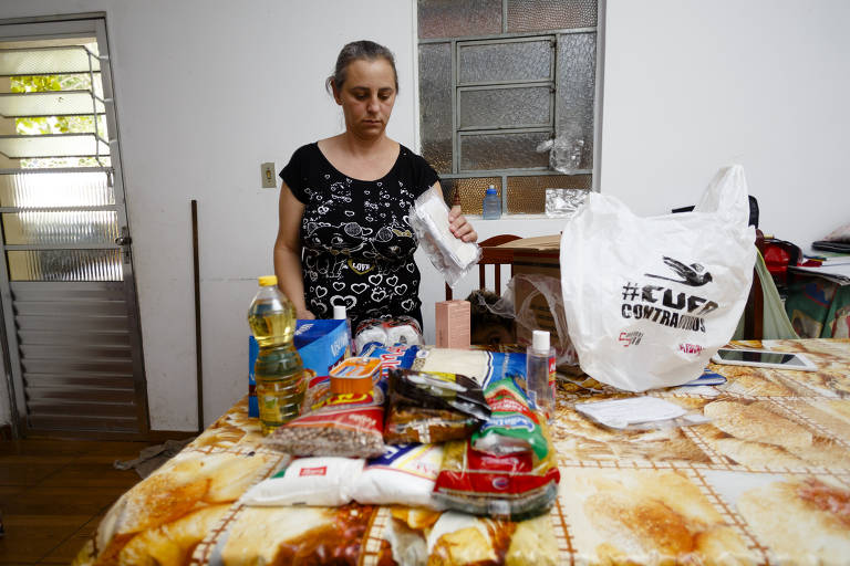 Carinada Massi Oliveira mostra alimentos recebidos através de doação. Ela e o seu marido, Moises Massi, estão desempregados e enfrentam as dificuldades financeiras causadas pela pandemia.