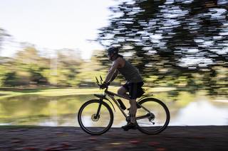 Homem anda de bicicleta no Parque do Ibirapuera