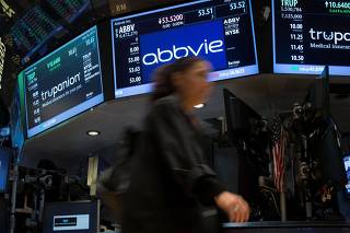 FILE PHOTO: A screen displays the share price for pharmaceutical maker AbbVie on the floor of the New York Stock Exchange