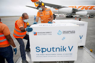 FILE PHOTO: Workers take care of the shipment of Russia's Sputnik V vaccine at the airport, in Caracas