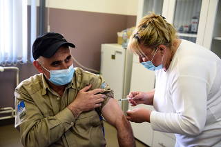 Nurse administers a dose of vaccine against the COVID-19, in Rudna Glava