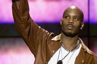 FILE PHOTO: Rapper DMX holds up his award after being named Male Entertainer of the Year at the 14th annual Soul Train Music Awards in Los Angeles