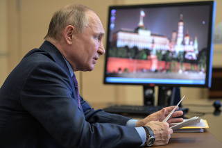 Russian President Putin takes part in a video conference call outside Moscow