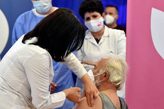 FILE PHOTO: A health worker prepares to administer the AstraZeneca vaccine under the COVAX scheme against the coronavirus disease (COVID-19) in Pristina