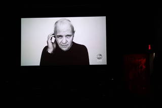 A picture of Anthony Hopkins, who won Best Actor but did not attend the Academy Awards in person, is shown during an Oscars watch party in New York