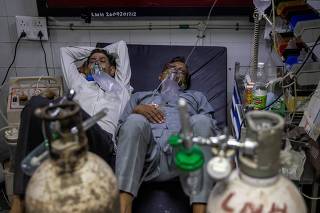 FILE PHOTO: Patients suffering from the coronavirus disease (COVID-19) get treatment at the casualty ward in Lok Nayak Jai Prakash (LNJP) hospital, amidst the spread of the disease in New Delhi