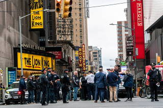 New York City police officers stand guard after a shooting incident in Times Square, New York