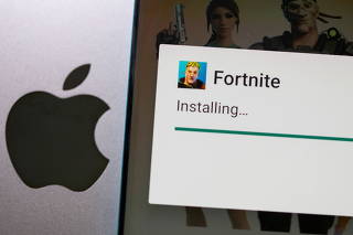 FILE PHOTO: Fortnite installing on Android is seen in front of Apple logo in this illustration