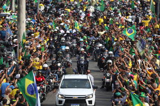 Brazil's President Bolsonaro leads a motorcade of supporters in Rio de Janeiro