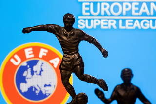 FILE PHOTO: Metal figures of football players are seen in front of the words 