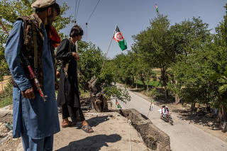 Police officers stand guard on the roof of their outpost near Mehtar Lam in Afghanistan?s Laghman Province on May 19, 2021. (Jim Huylebroek/The New York Times)