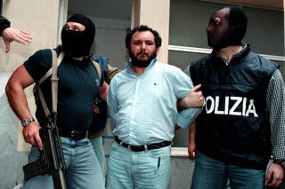 FILE PHOTO: Anti-Mafia police wearing masks to hide their identity, escort top Mafia fugitive Giovani Brusca May..