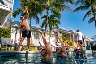 Instructor Peter Rogers teaches an aqua yoga class, put on hiatus during the coronavirus pandemic, at the Marker Key West Harbor Resort in Key West, Fla., on Feb. 13, 2021. (Mark Hedden/The New York Times)