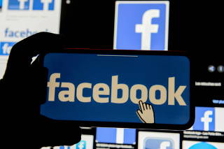 FILE PHOTO: The Facebook logo is displayed on a mobile phone